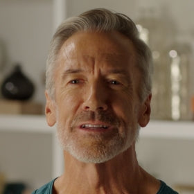 Man with gray hair and beard in a casual setting